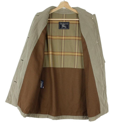 Burberry khaki green quilted coat with wool lining and classic logo detail.