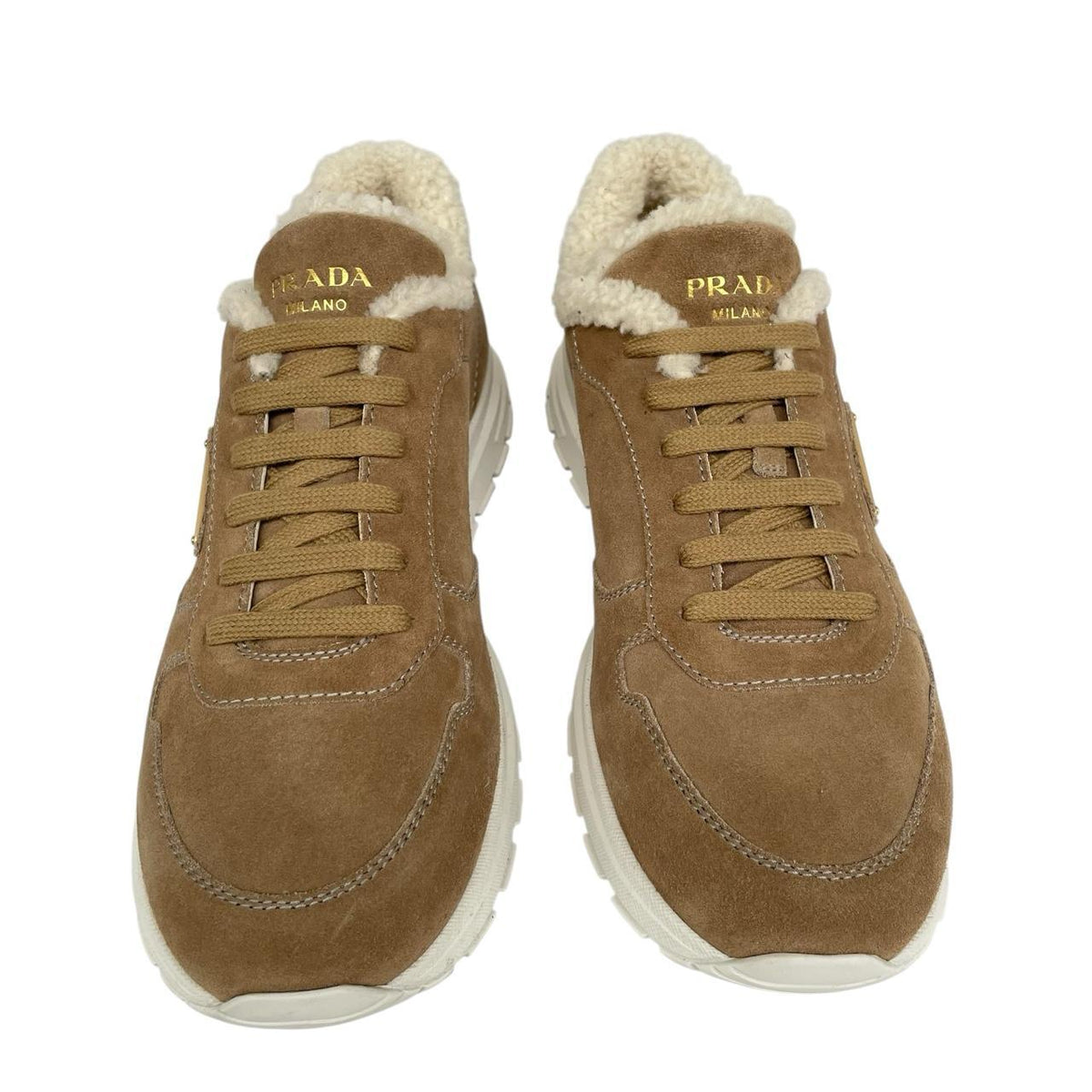 Prada brown suede trainers with shearling lining and logo detail.