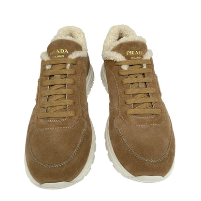 Prada brown suede trainers with shearling lining and logo detail.