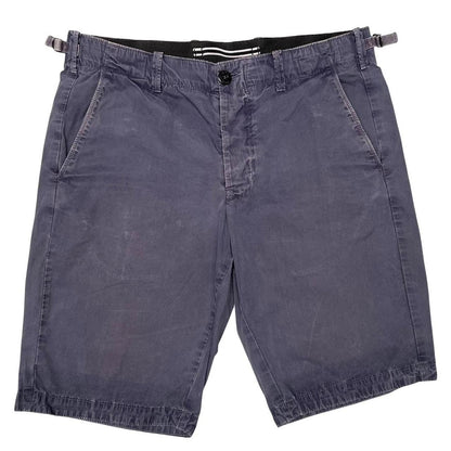 Stone Island navy blue Bermuda shorts with logo patch and cotton material.