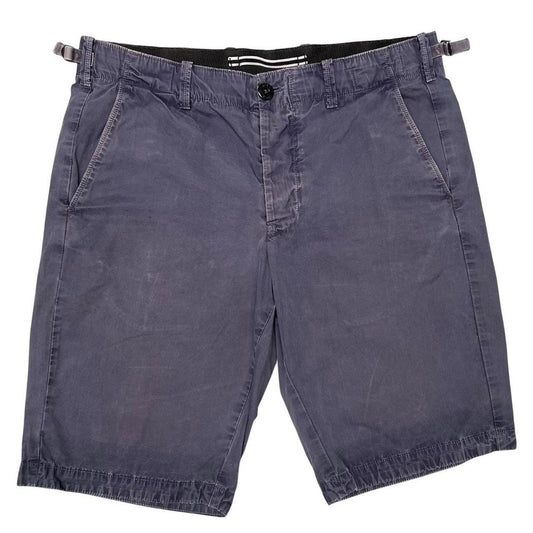 Stone Island navy blue Bermuda shorts with logo patch and cotton material.