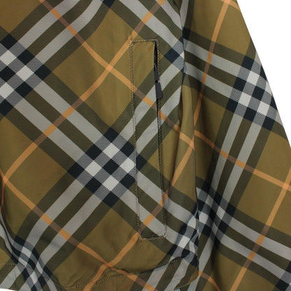 Burberry reversible nylon jacket in brown and black Nova Check pattern with logo.