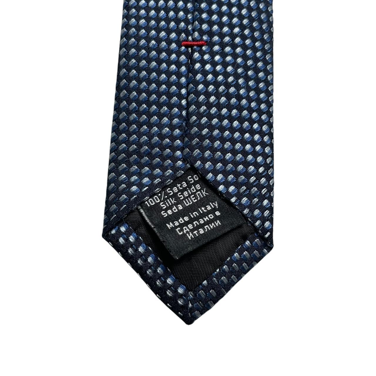 Hugo Boss blue silk tie with white polka dots and logo detail.