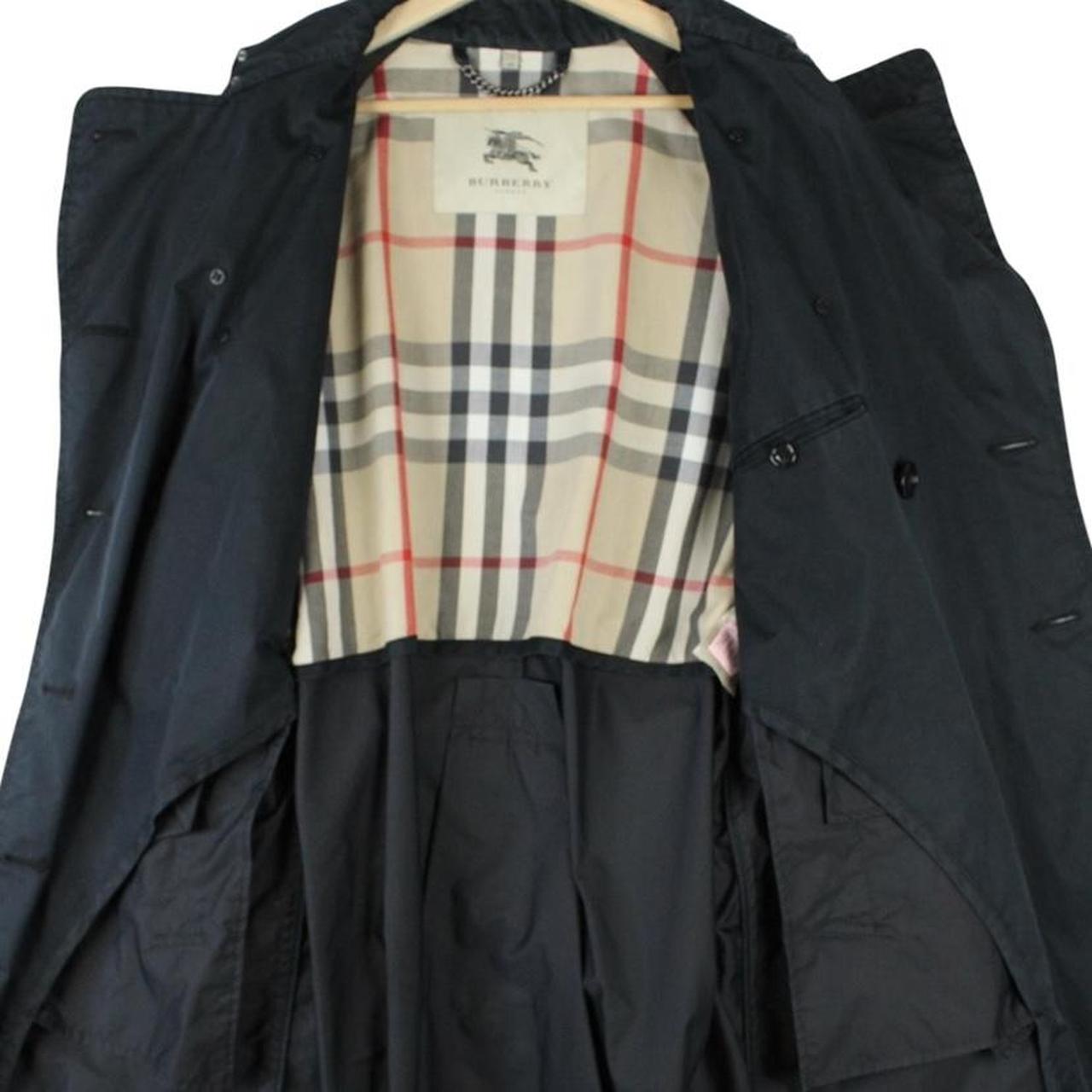 Burberry beige double breasted belted trench coat with classic check lining and logo detail.