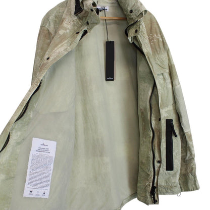 Stone Island green full zip jacket with dissolving grid camo pattern and logo patch.