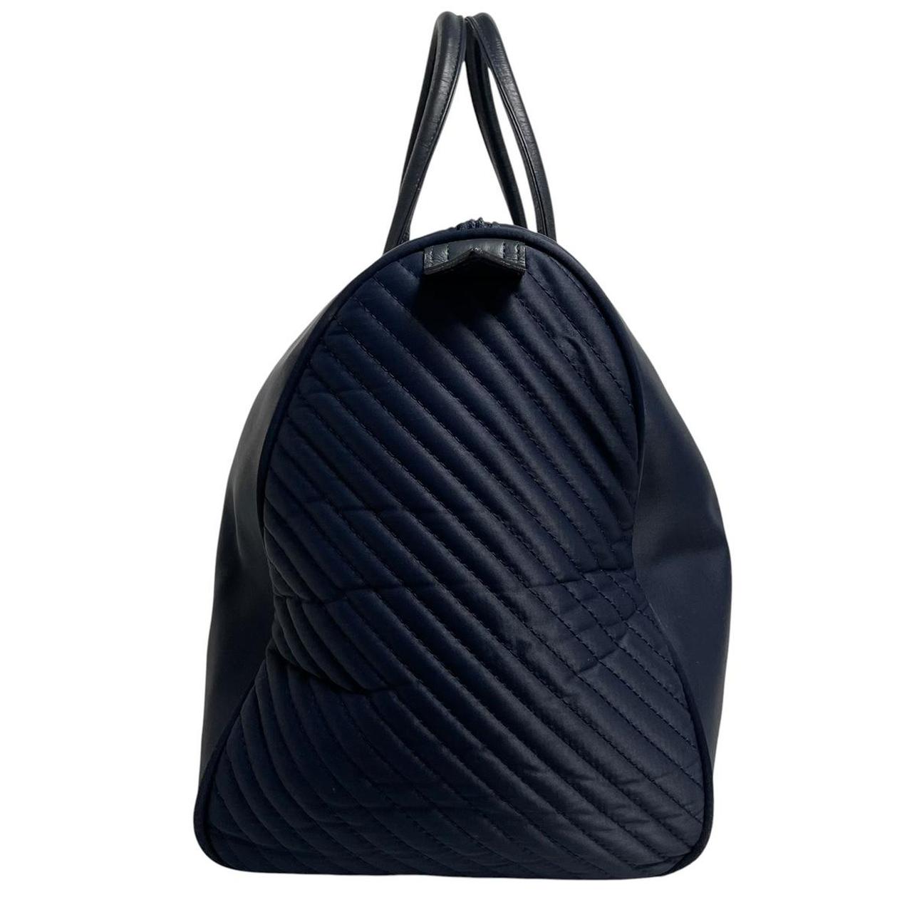 Yves Saint Laurent navy blue duffel bag embossed logo nylon material with handles.
