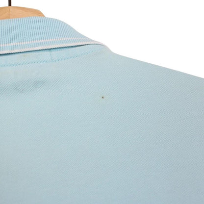 Stone Island blue polo shirt with embroidered compass logo and slim fit cotton material.
