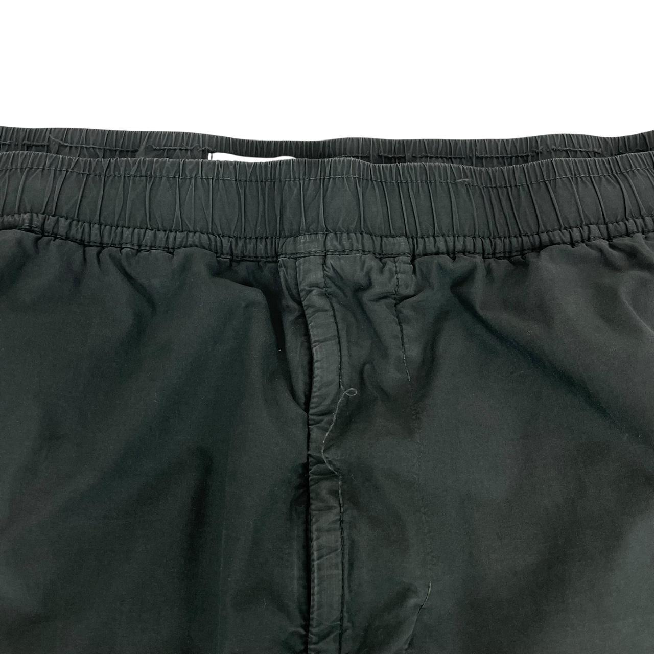 Stone Island grey cargo trousers with logo patch and loose stitch detail.