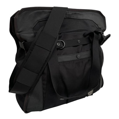 Stone Island black nylon tote bag with logo patch and crossbody strap.