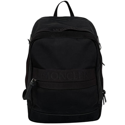 Moncler black duffel bag with logo patch and durable material, pre-loved condition.