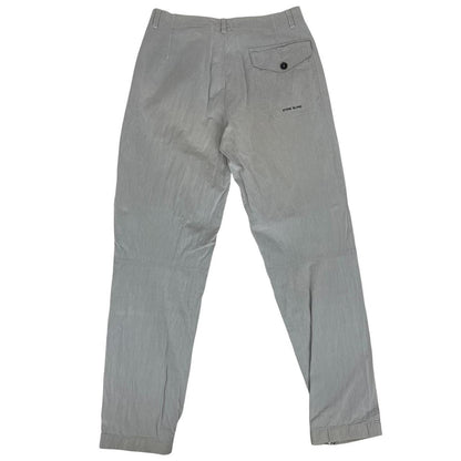 Stone Island grey tapered fit trousers with logo patch and cotton material.
