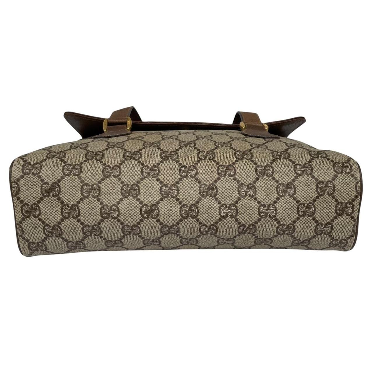 Gucci brown duffel bag with monogram canvas and top handle design.