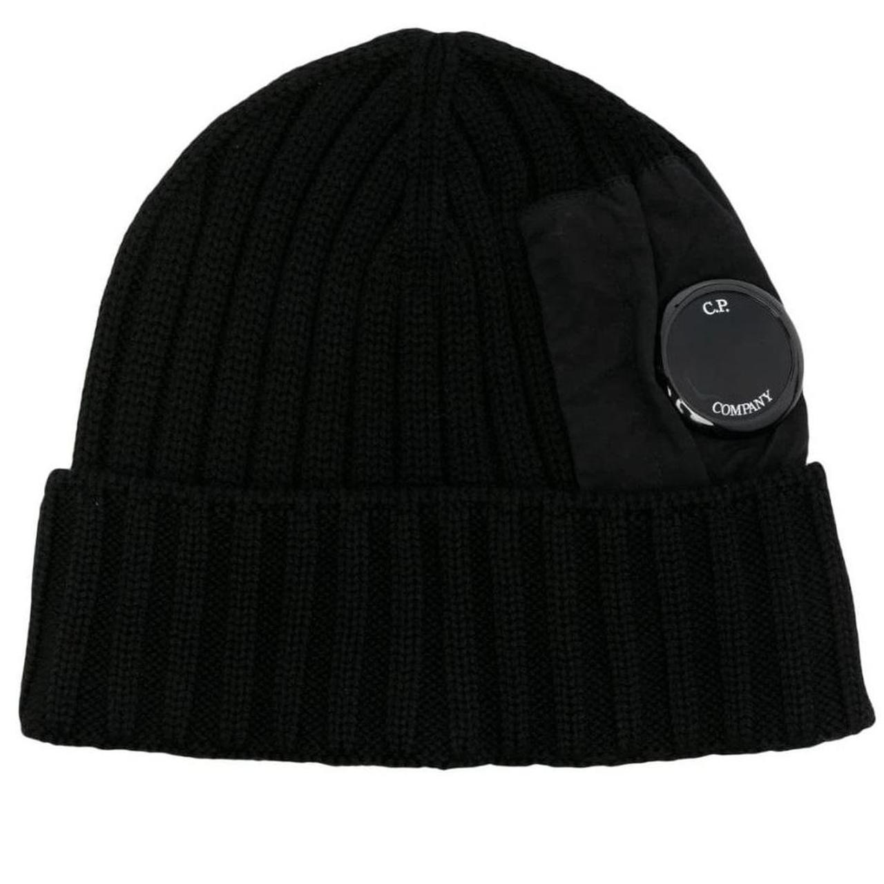 CP Company black beanie hat made of extra fine merino wool with side lens detail.