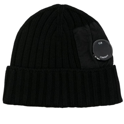 CP Company black beanie hat made of extra fine merino wool with side lens detail.