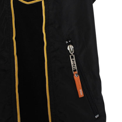 Christian Dior black and yellow jacket with 'Remove Before Flight' graphic detail.