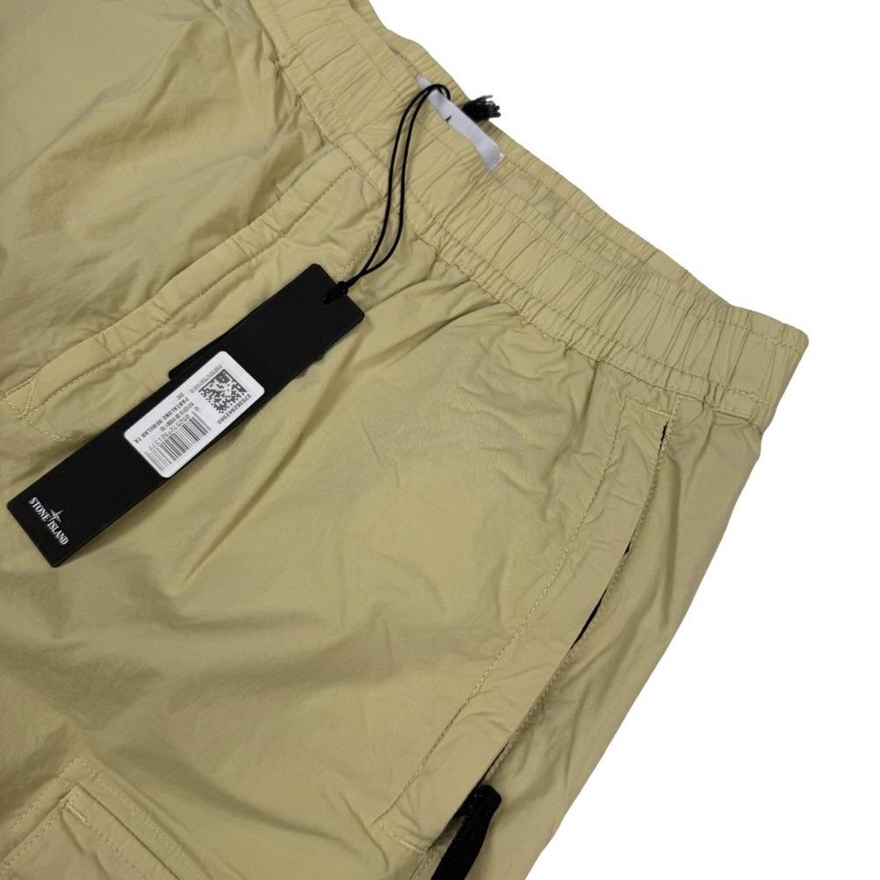 Stone Island beige cargo trousers with logo patch and stretch cotton material.