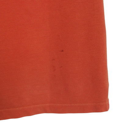 Stone Island orange short sleeve polo shirt with compass logo and cotton material.