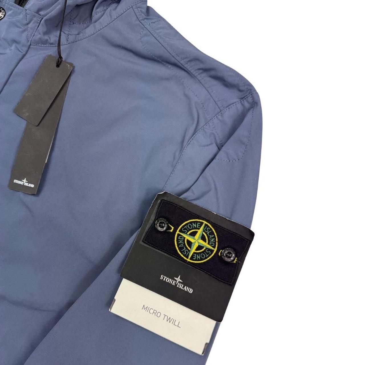 Stone Island blue hooded jacket with logo patch and micro twill fabric.