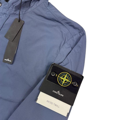 Stone Island blue hooded jacket with logo patch and micro twill fabric.