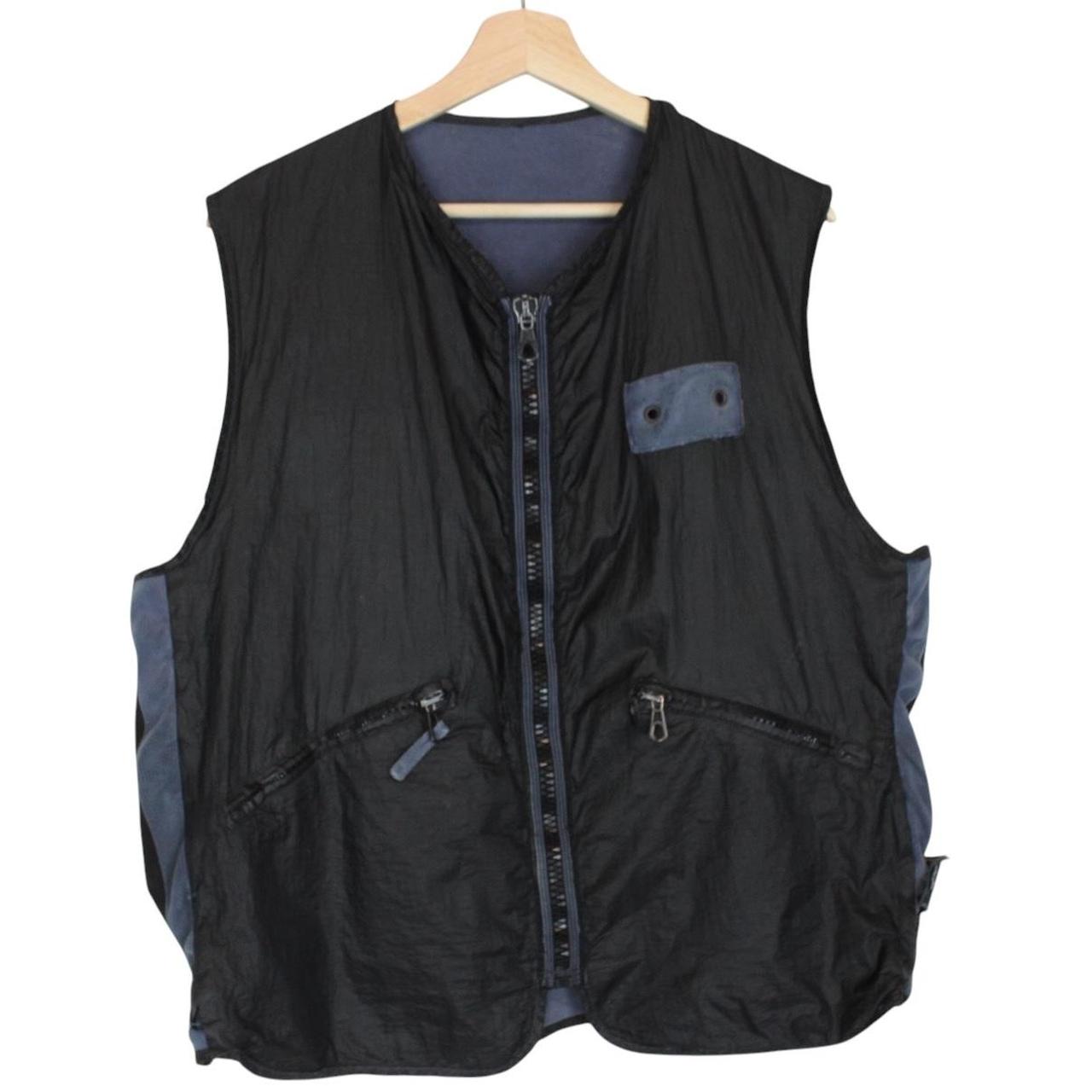 Stone Island navy blue reversible vest with green edge and logo patch detail.