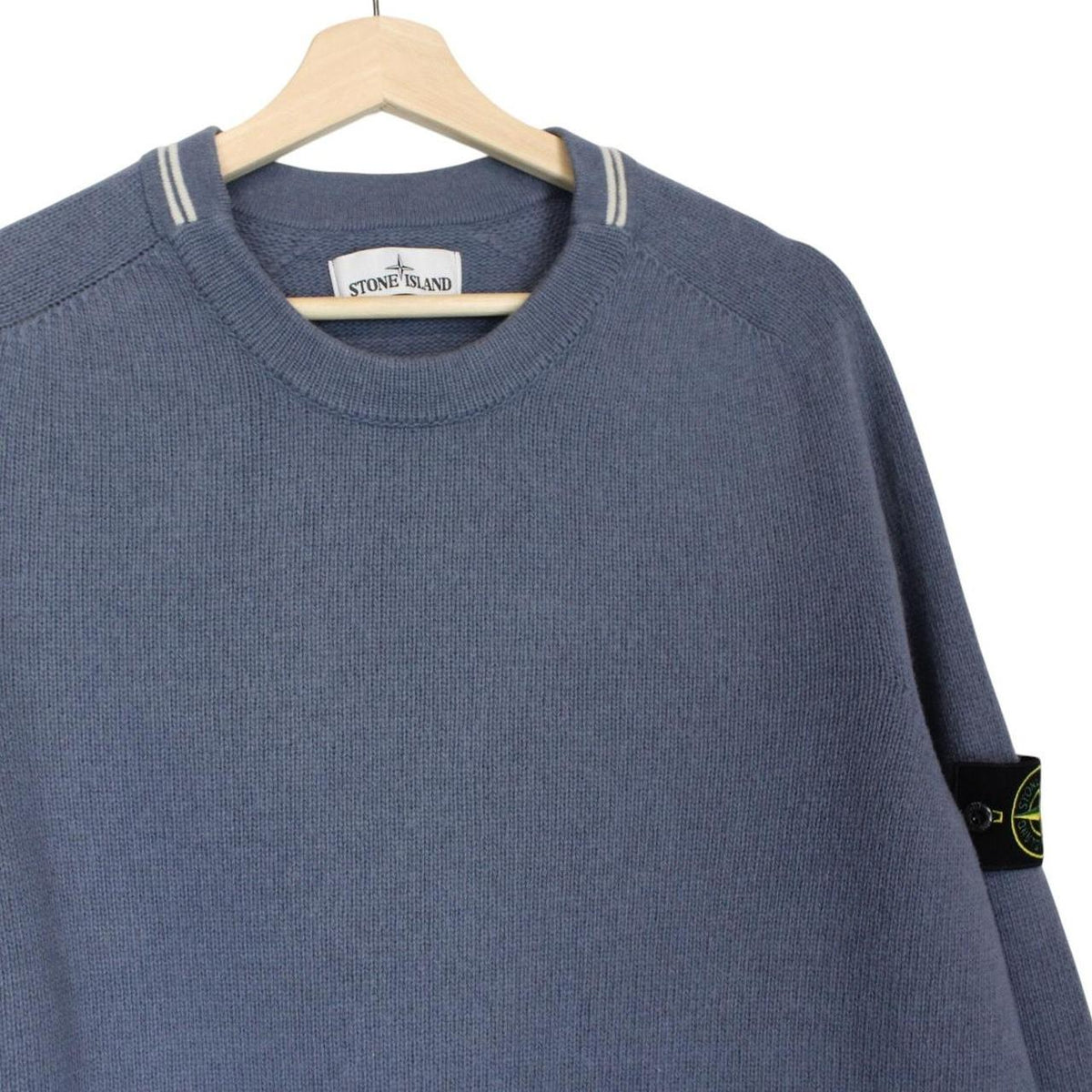 Stone Island blue wool knit jumper with logo patch and ribbed cuffs.