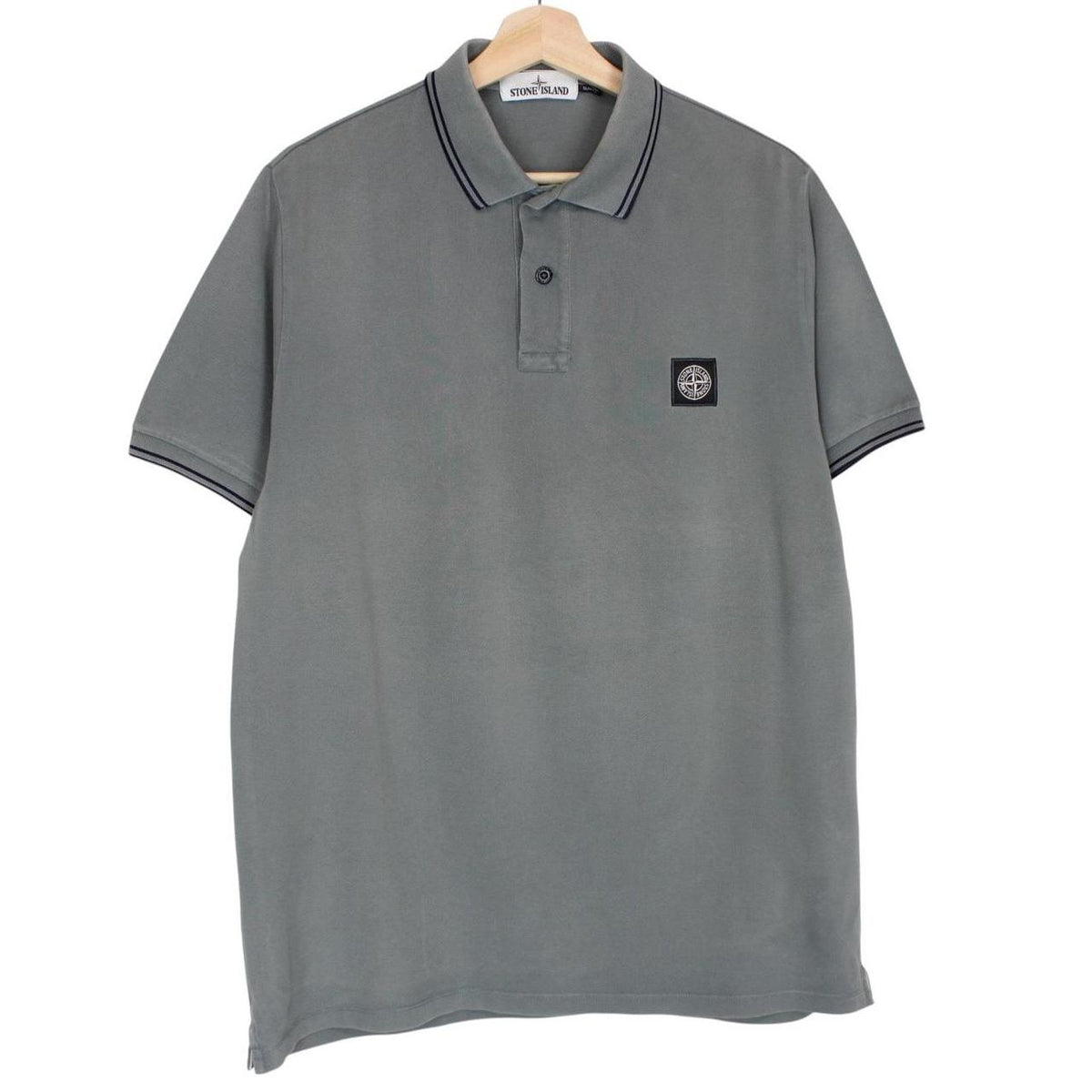 Stone Island grey polo shirt with embroidered compass logo and cotton material.