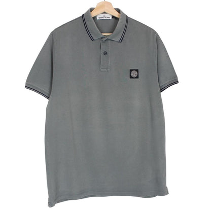 Stone Island grey polo shirt with embroidered compass logo and cotton material.