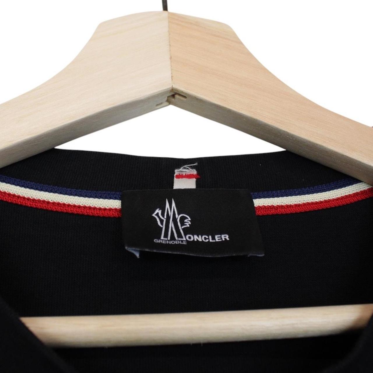 Moncler black and white short sleeve t-shirt with vertical logo design.