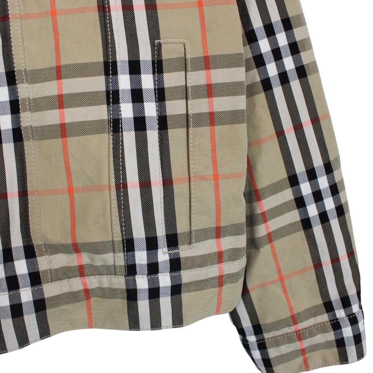 Burberry beige denim jacket featuring iconic Nova Check pattern and logo detail.
