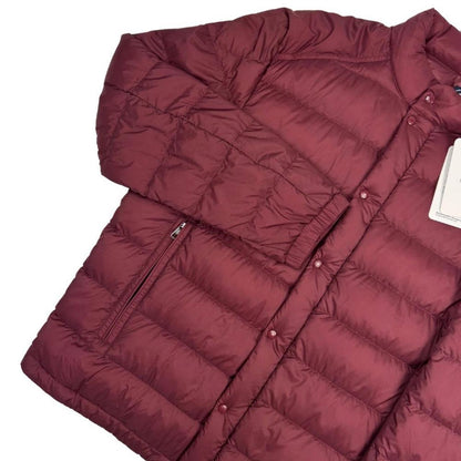 Moncler burgundy quilted down jacket with logo patch and shell material.