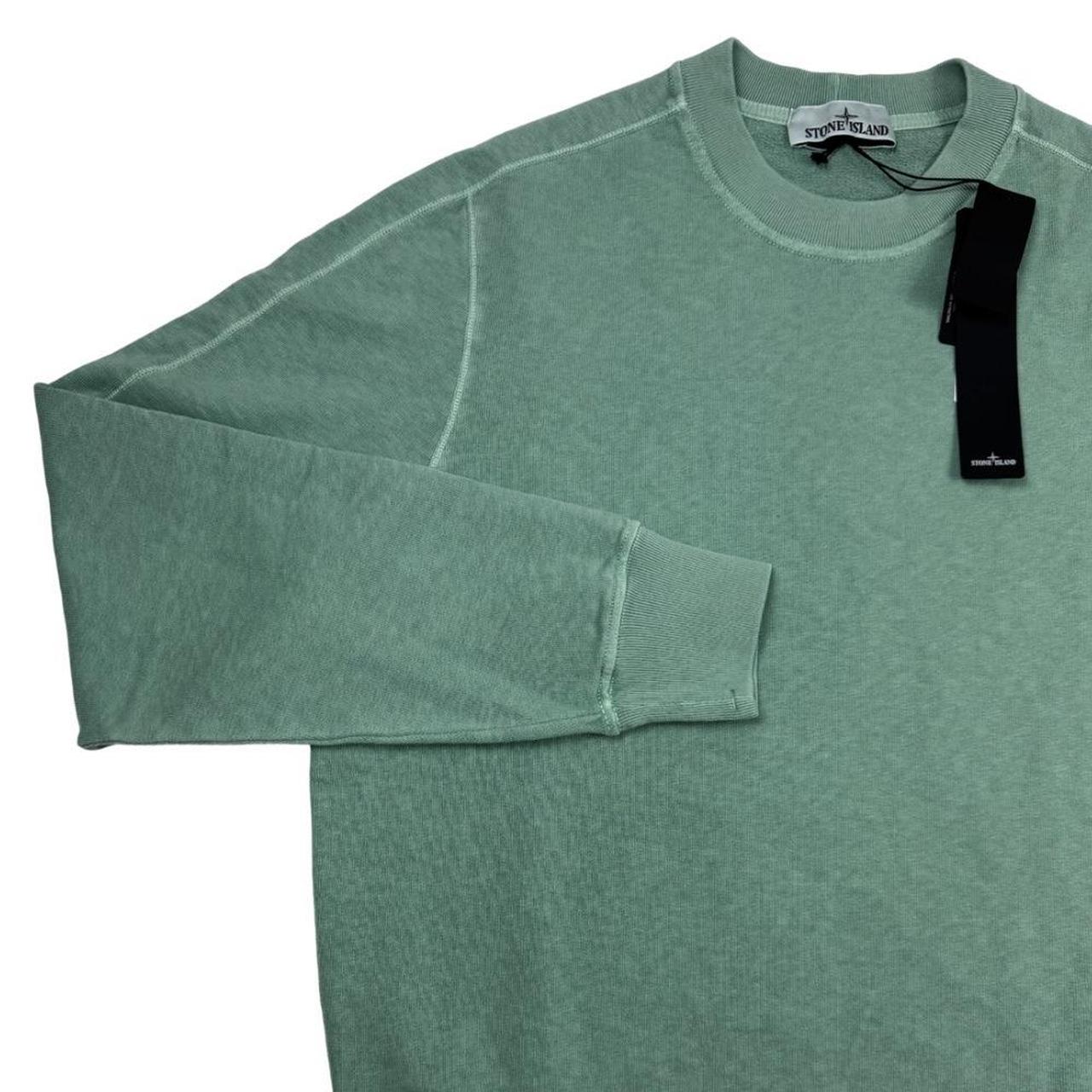 Stone Island green sweatshirt with logo patch and garment dyed cotton material.