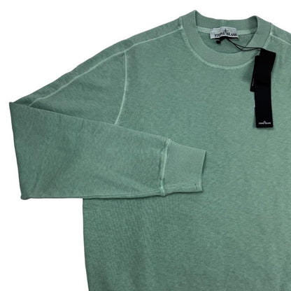 Stone Island green sweatshirt with logo patch and garment dyed cotton material.