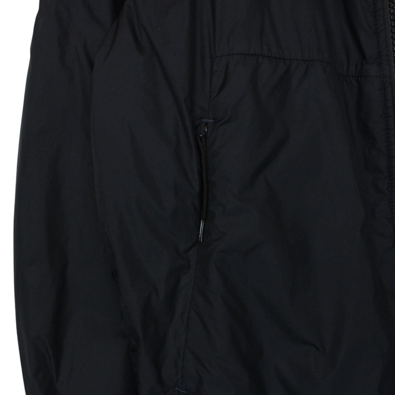 Stone Island black jacket with crinkle texture and logo patch on sleeve.