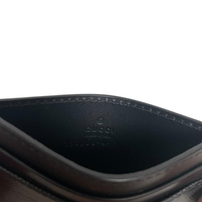 Gucci black card holder featuring Supreme GG monogram pattern in leather and canvas.