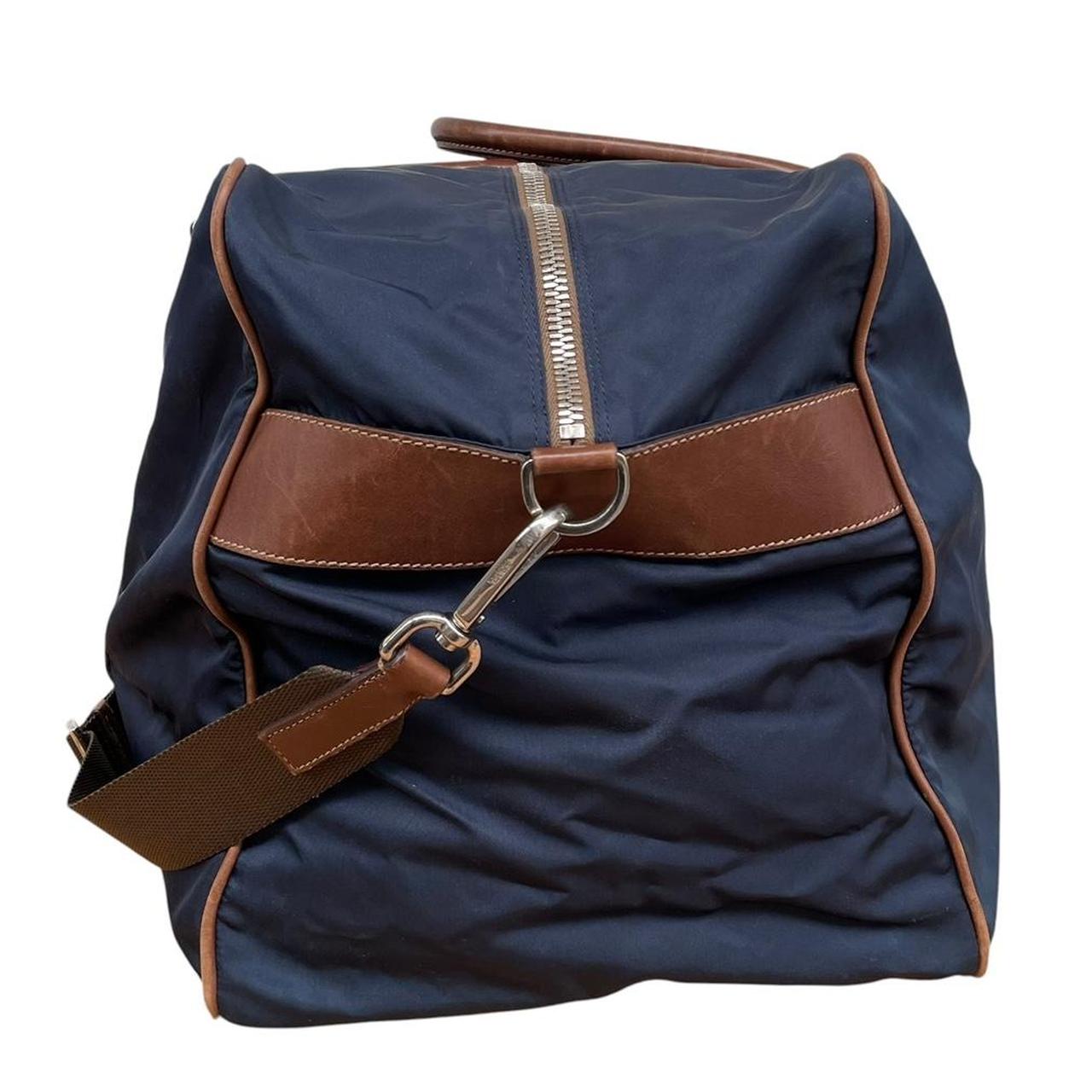 Prada navy blue and brown nylon duffel bag with signature logo and minimal wear.