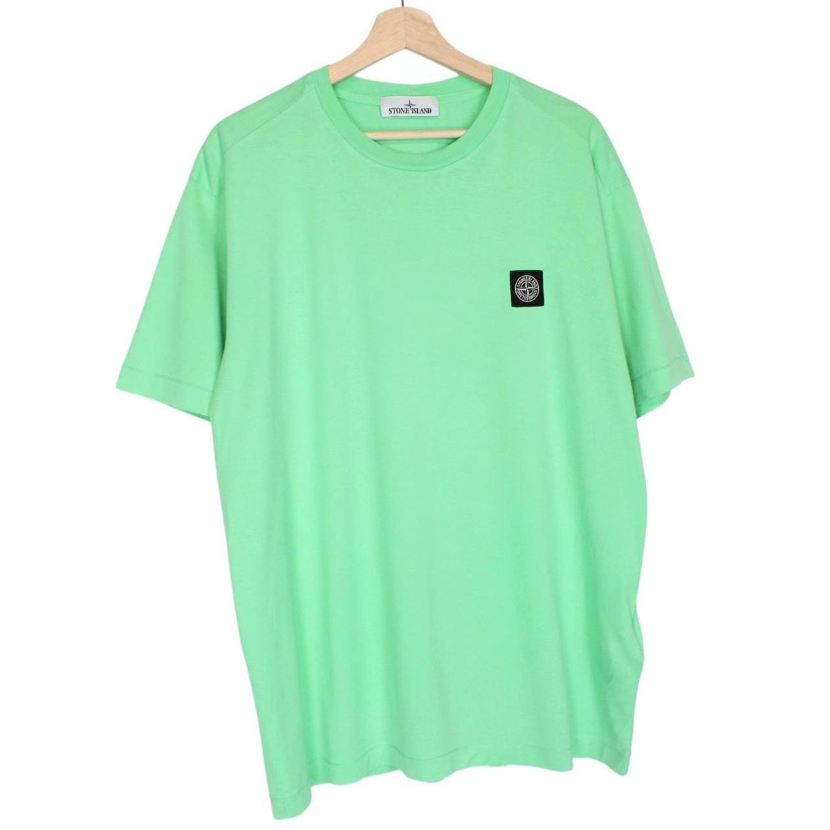 Stone Island green short sleeve cotton t-shirt with compass logo and tag detail.