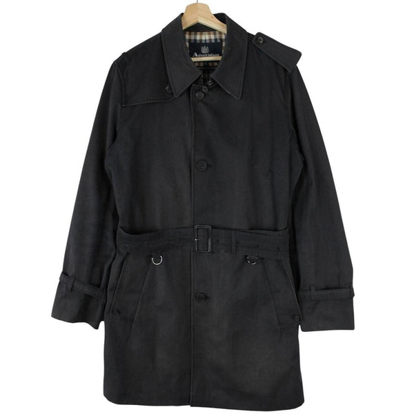 Aquascutum black trench coat with house check pattern and belted waist detail.