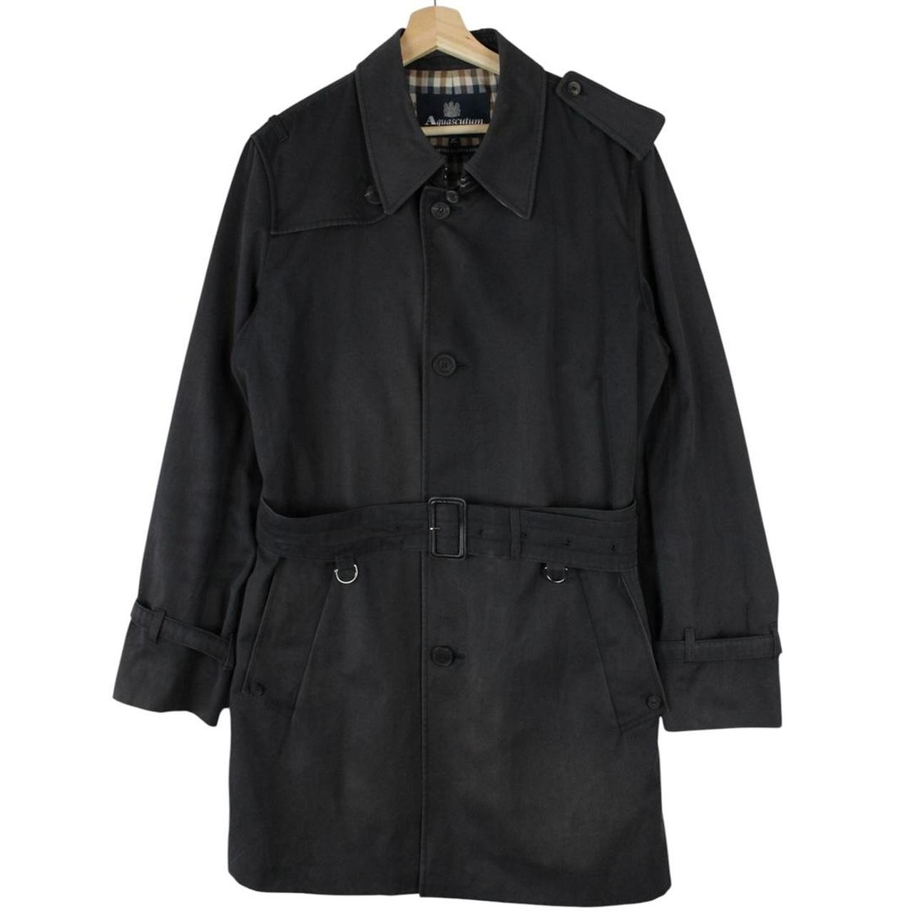 Aquascutum black trench coat with house check pattern and belted waist detail.