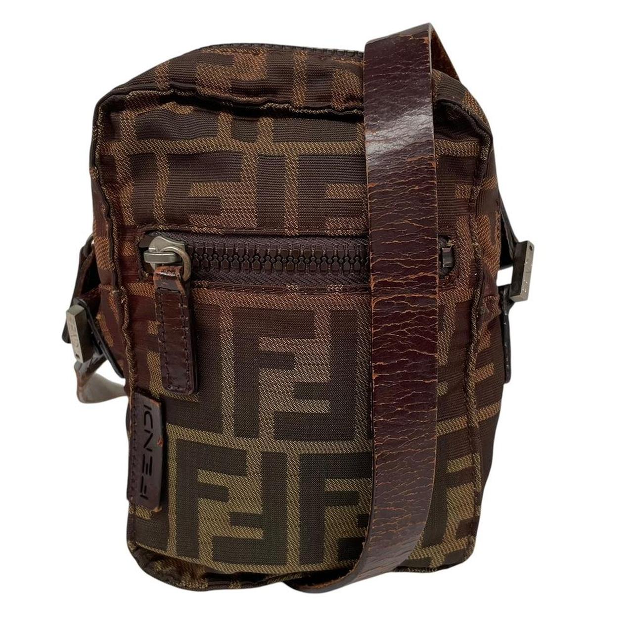 Fendi brown duffel bag with monogram canvas, visible wear and cracking on strap.