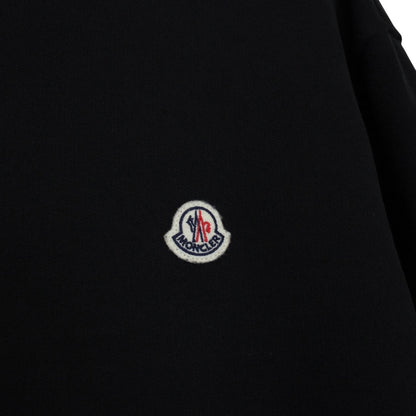 Moncler black hoodie jumper featuring logo patch and cotton material.