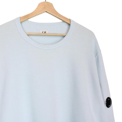 CP Company light blue sweatshirt with signature lens detail and cotton fabric.