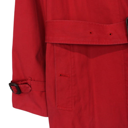Burberry red trench coat with Nova Check pattern and belted waist detail.