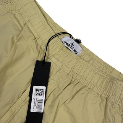 Stone Island beige cargo trousers with logo patch and stretch cotton material.