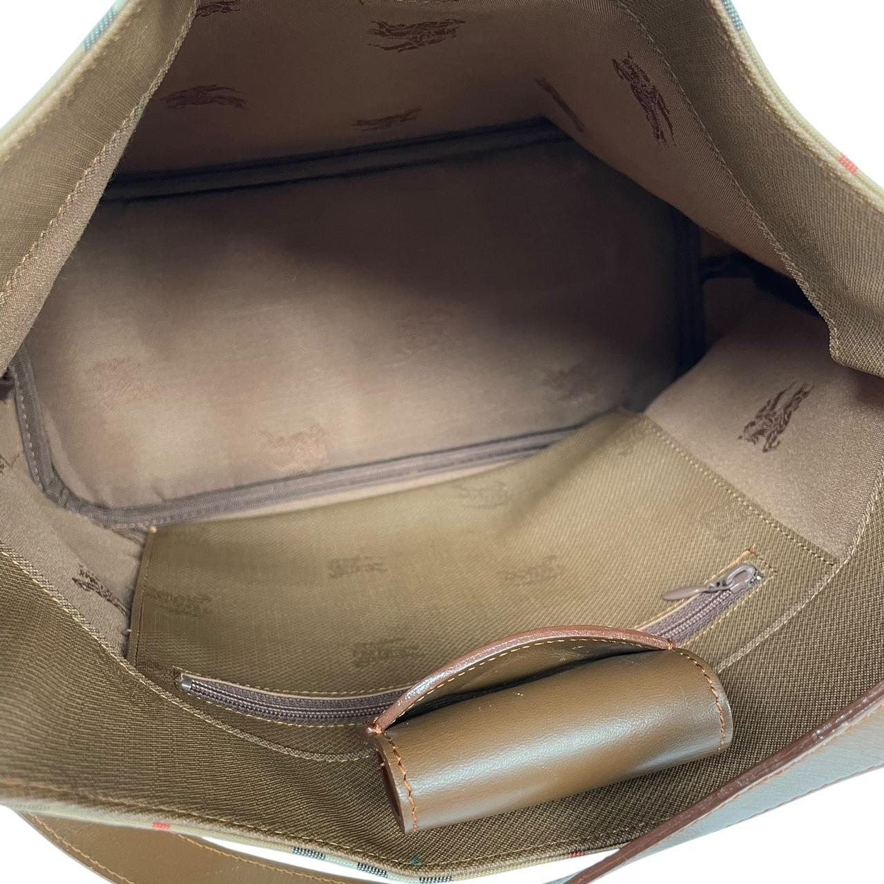 Burberry tan brown duffel bag featuring iconic Nova Check pattern and leather accents.