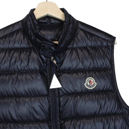Moncler navy blue down gilet with logo patch and quilted design.