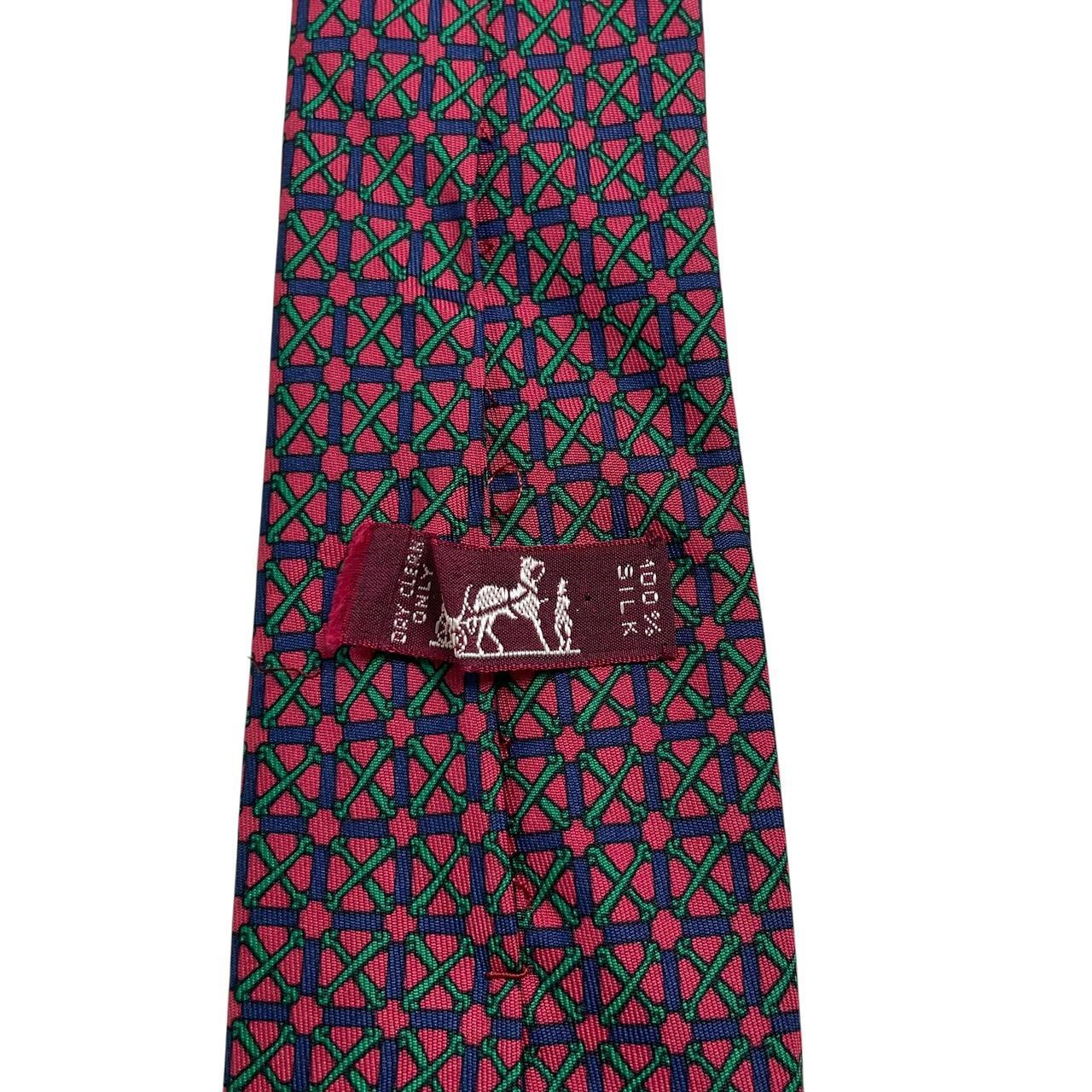 Hermes silk tie featuring geometric print in red, blue, and green colors.