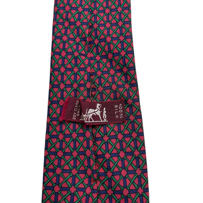 Hermes silk tie featuring geometric print in red, blue, and green colors.