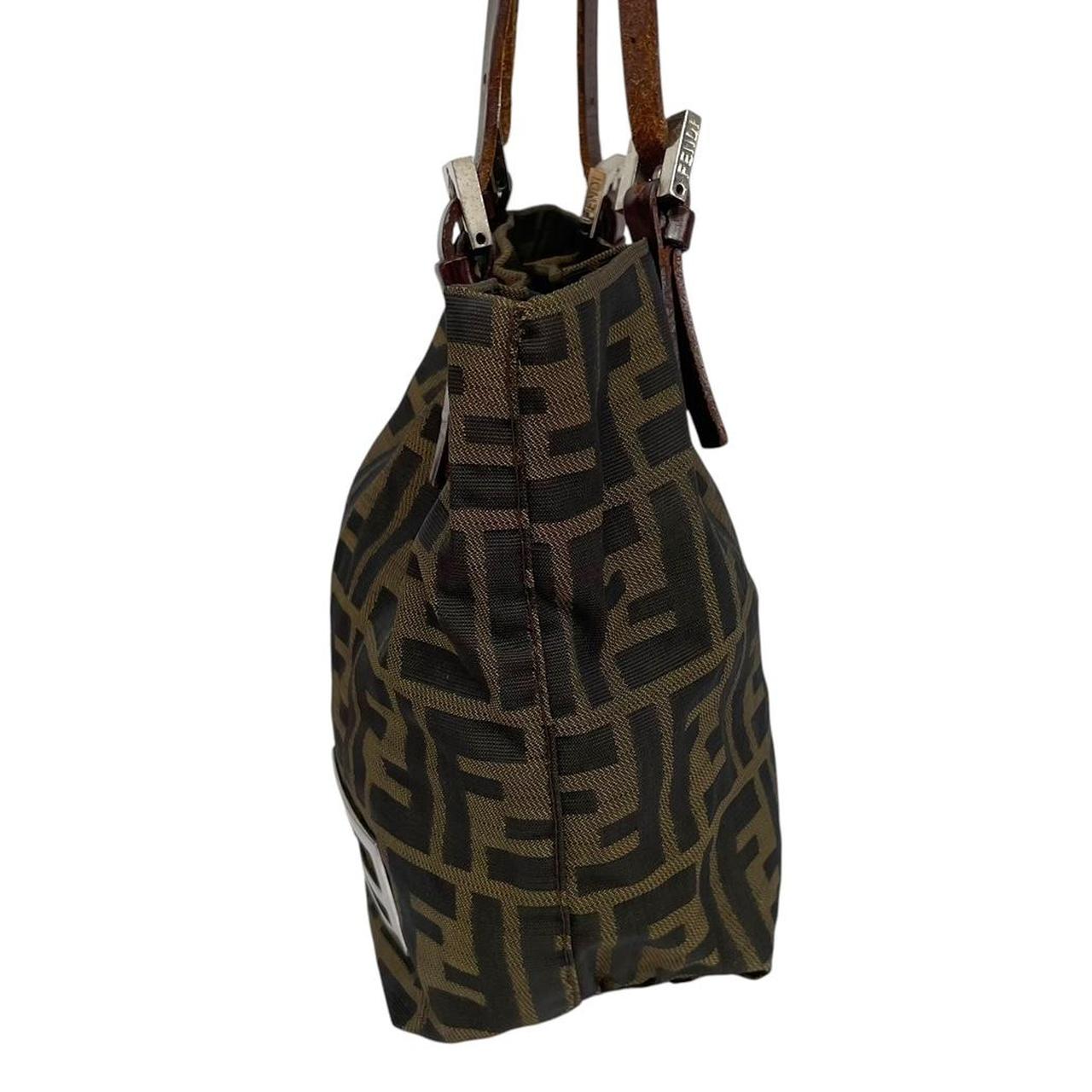 Fendi brown duffel bag featuring iconic Zucca monogram canvas and durable handles.