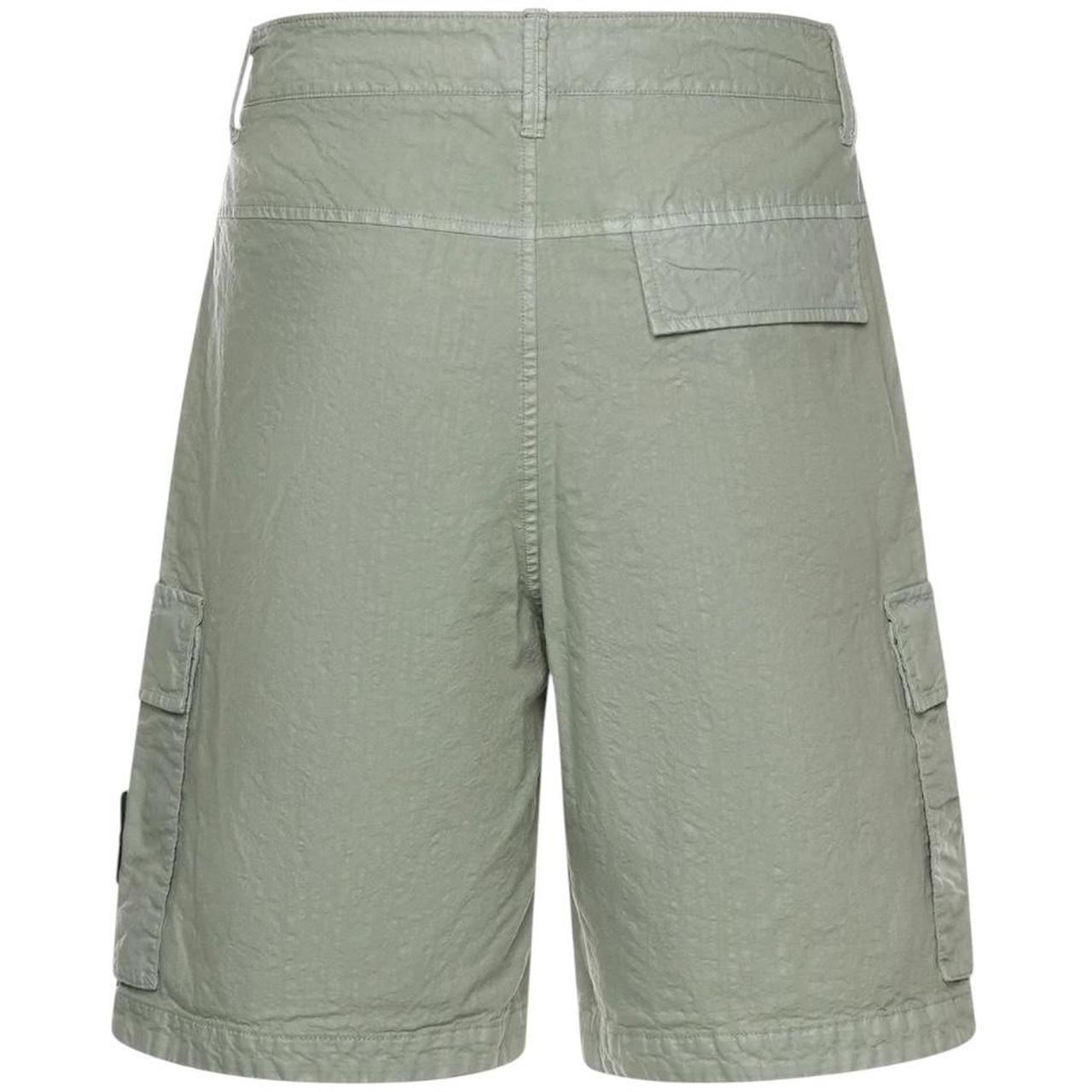 Stone Island green cargo shorts with multiple pockets and "OLD" effect garment-dye treatment.