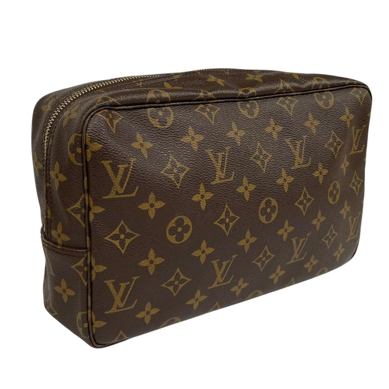Louis Vuitton brown and tan monogram toiletry pouch with iconic logo and canvas material.